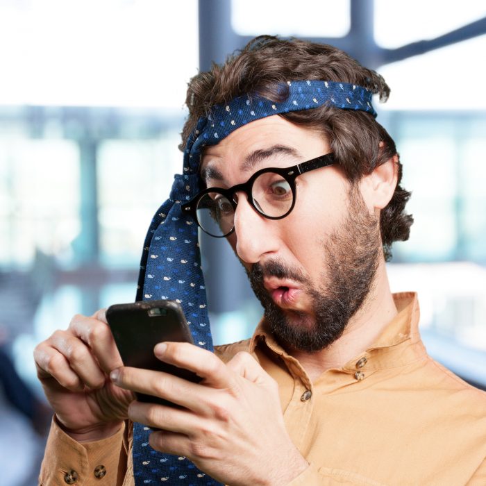 crazy man with mobile phone.funny expression